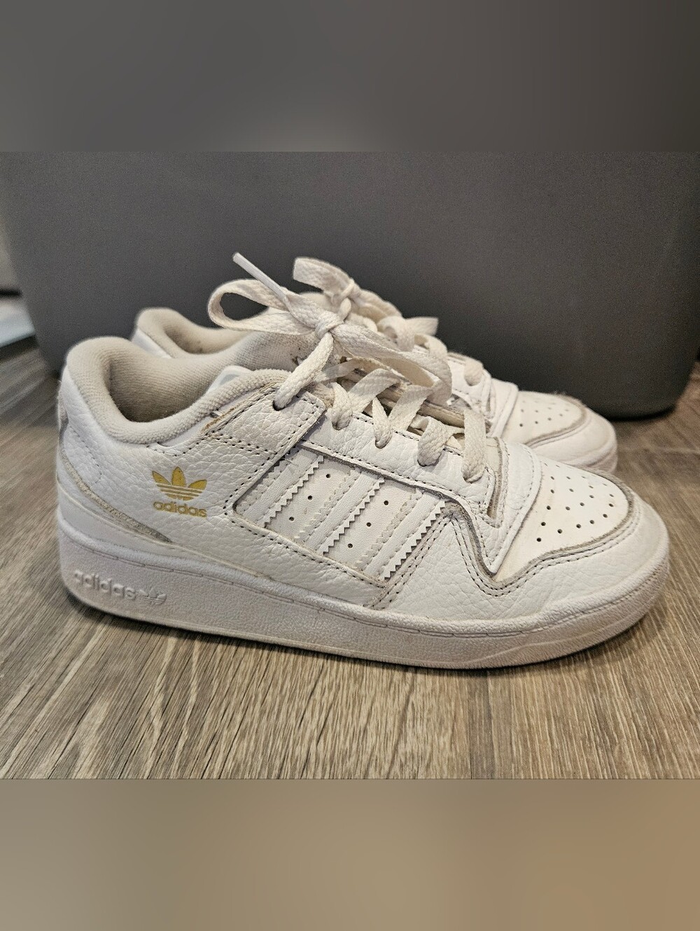 Adidas Forum Low sneakers in a white colorway with rose gold accents